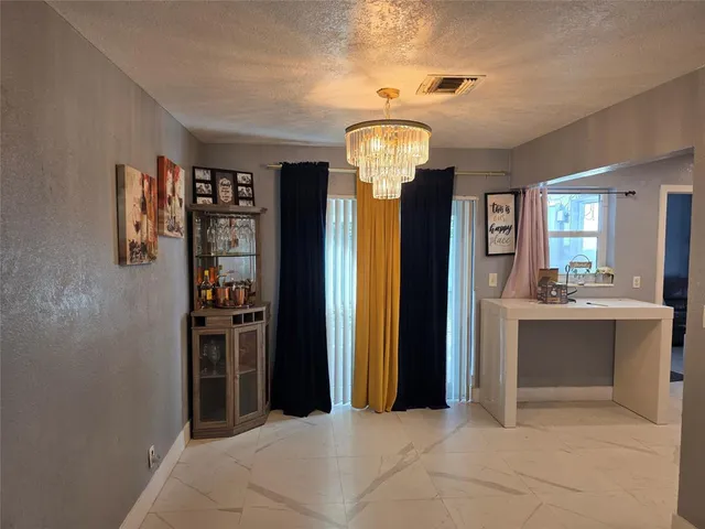 a view of living room and kitchen with a window