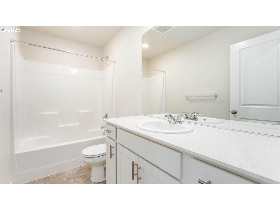 2957 T Street Springfield, OR 97477 - Photo 19 of 27 a bathroom with a sink toilet a mirror and shower