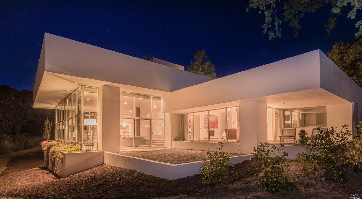 a living room with furniture and large windows