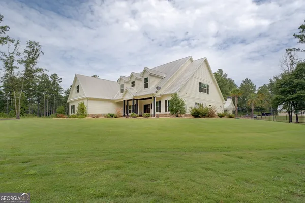 a view of a house with a yard and garage