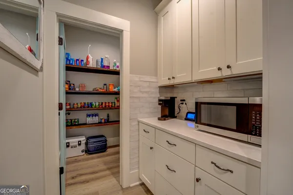 a en suite bathroom with a granite countertop double vanity sink and a mirror