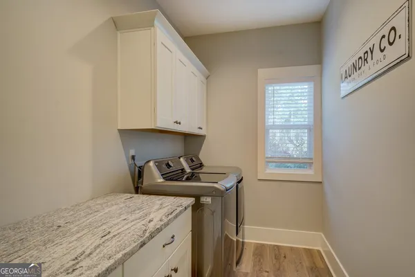 a bathroom with a granite countertop toilet sink and mirror