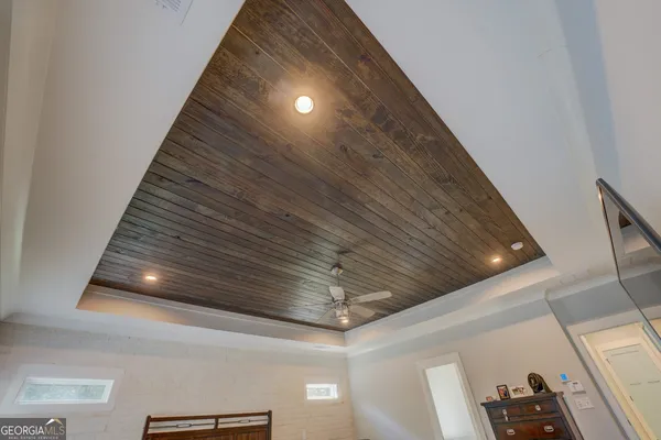 a view of a porch with furniture and a yard