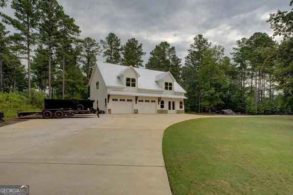 a front view of house with yard and green space