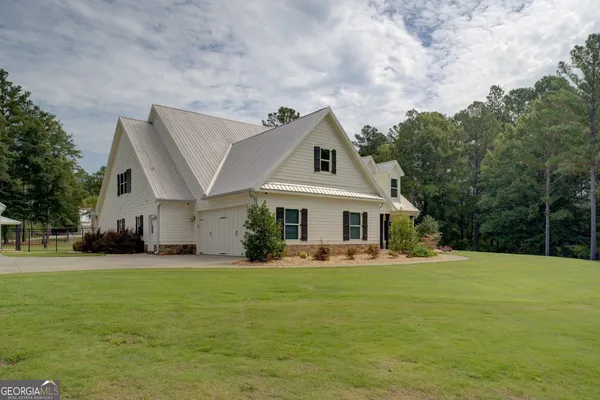 an aerial view of a house with outdoor space and sitting space