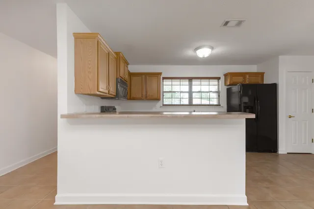 a kitchen with stainless steel appliances a refrigerator and a stove top oven