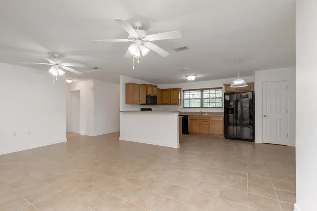 a view of a kitchen with a sink and a ceiling fan