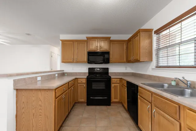a kitchen with stainless steel appliances granite countertop a stove sink and microwave