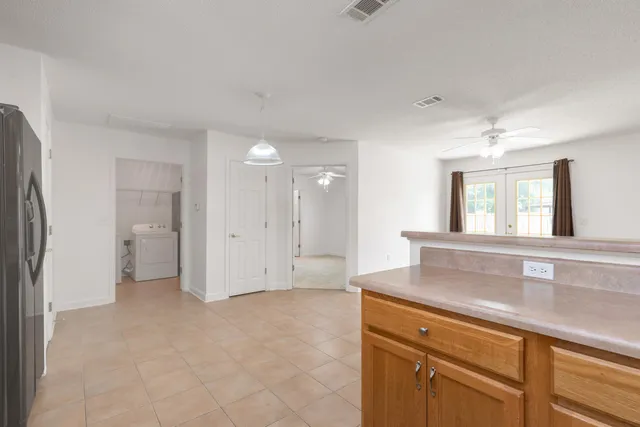 a living room with a sink and a refrigerator