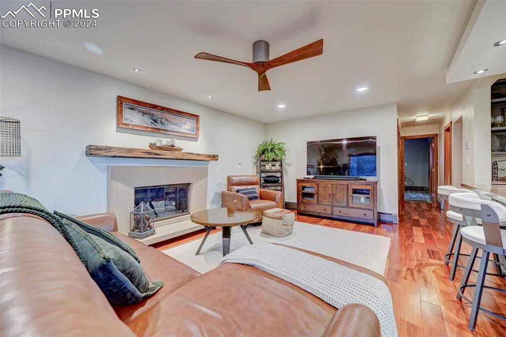 1306 Limerock Lane Colorado Springs, CO 80906 - Photo 11 of 50 a living room with furniture and a fireplace