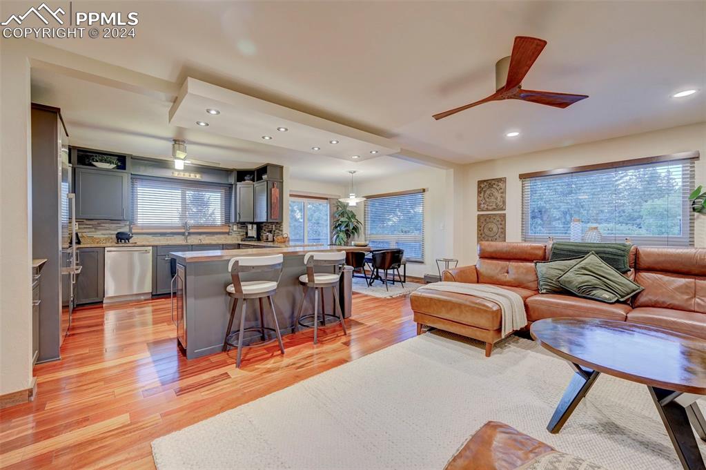 1306 Limerock Lane Colorado Springs, CO 80906 - Photo 12 of 50 a living room with furniture kitchen view and a large window
