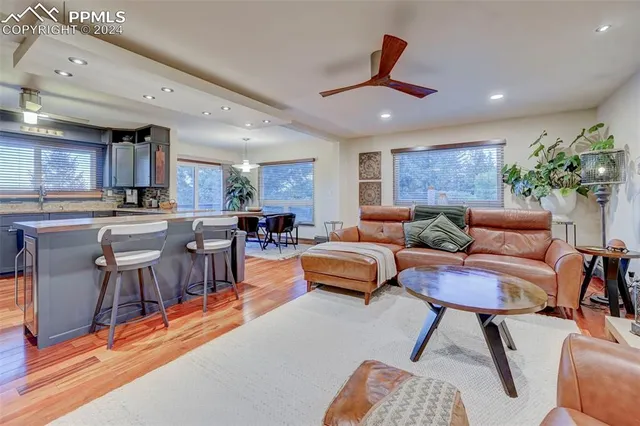 a living room with furniture and kitchen view