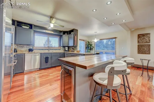 a large kitchen with a table and chairs in it