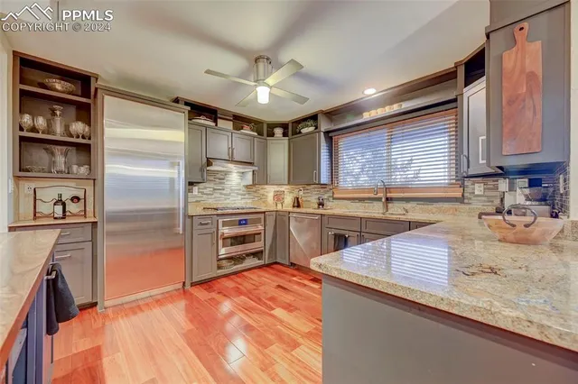 a kitchen with a refrigerator sink and cabinets