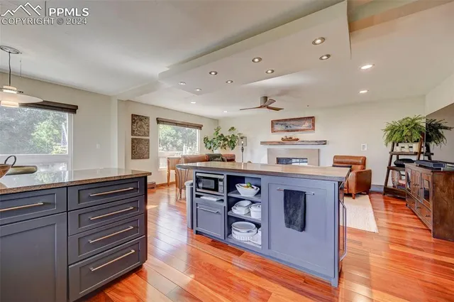 a kitchen with stainless steel appliances granite countertop a stove and a sink with cabinets