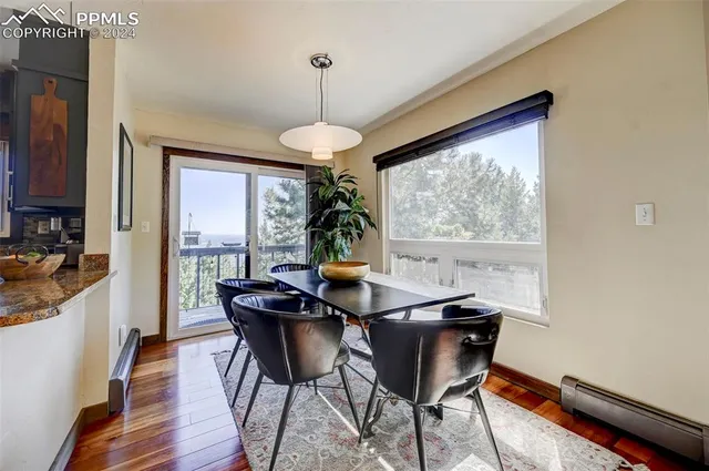 a view of a dining room with furniture wooden floor and chandelier