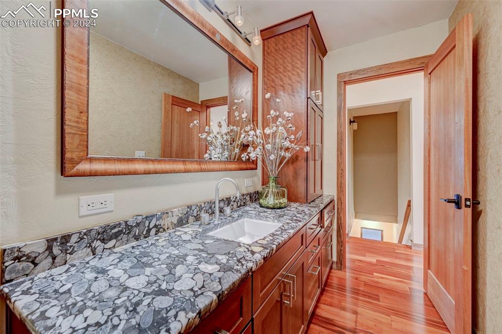 1306 Limerock Lane Colorado Springs, CO 80906 - Photo 21 of 50 a bathroom with a granite countertop sink and a mirror