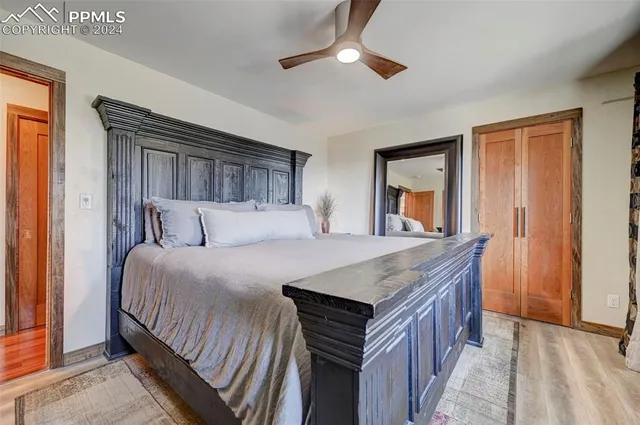 a bedroom with a bed and a chandelier