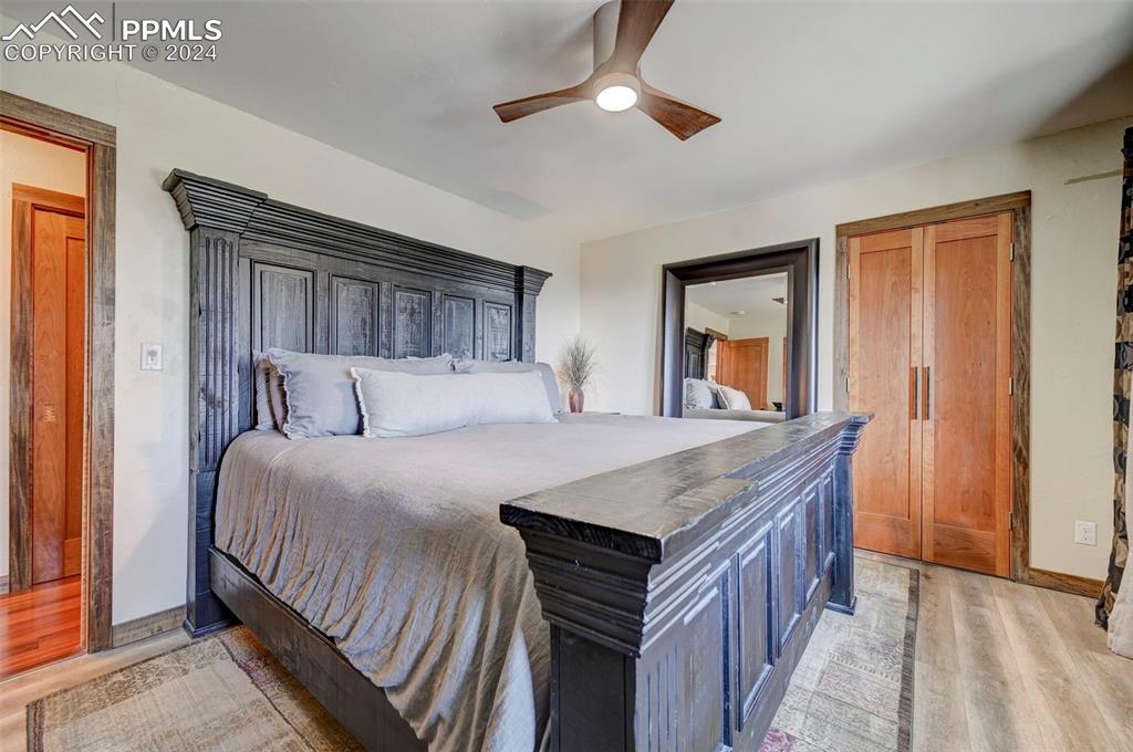 1306 Limerock Lane Colorado Springs, CO 80906 - Photo 24 of 50 a bedroom with a bed and a chandelier