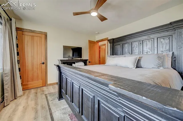 a bedroom with a bed and a flat tv screen