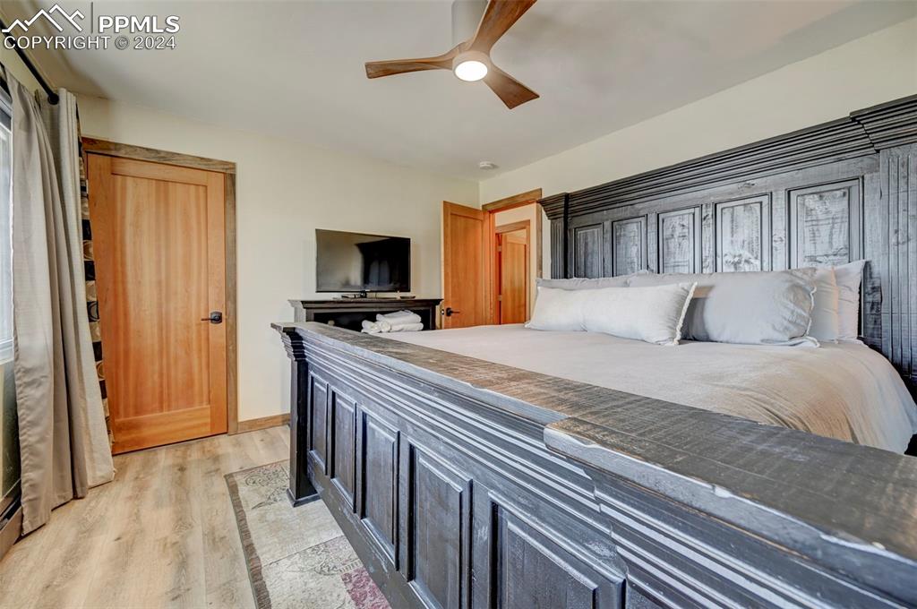 1306 Limerock Lane Colorado Springs, CO 80906 - Photo 25 of 50 a bedroom with a bed and a flat tv screen