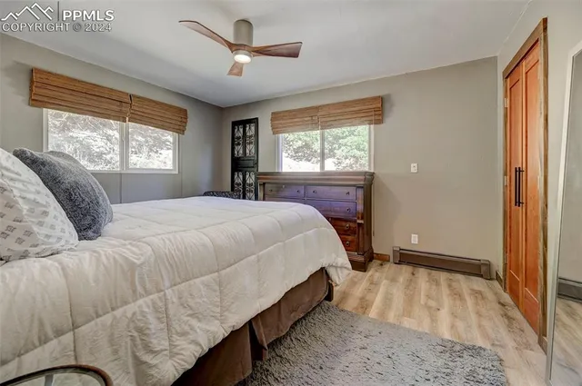 a bed room with a bed and a large window