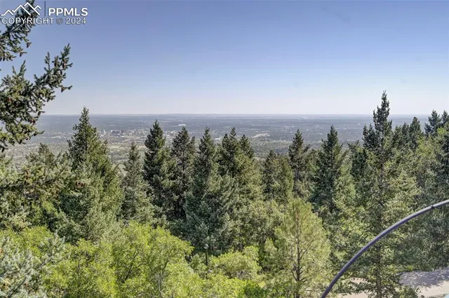 a view of a balcony with wooden floor and outdoor space