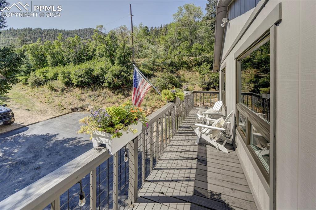 1306 Limerock Lane Colorado Springs, CO 80906 - Photo 43 of 50 a view of a balcony with wooden floor and outdoor space