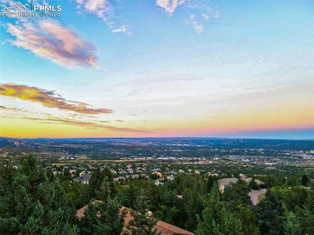 an aerial view of residential houses with city view and mountain view