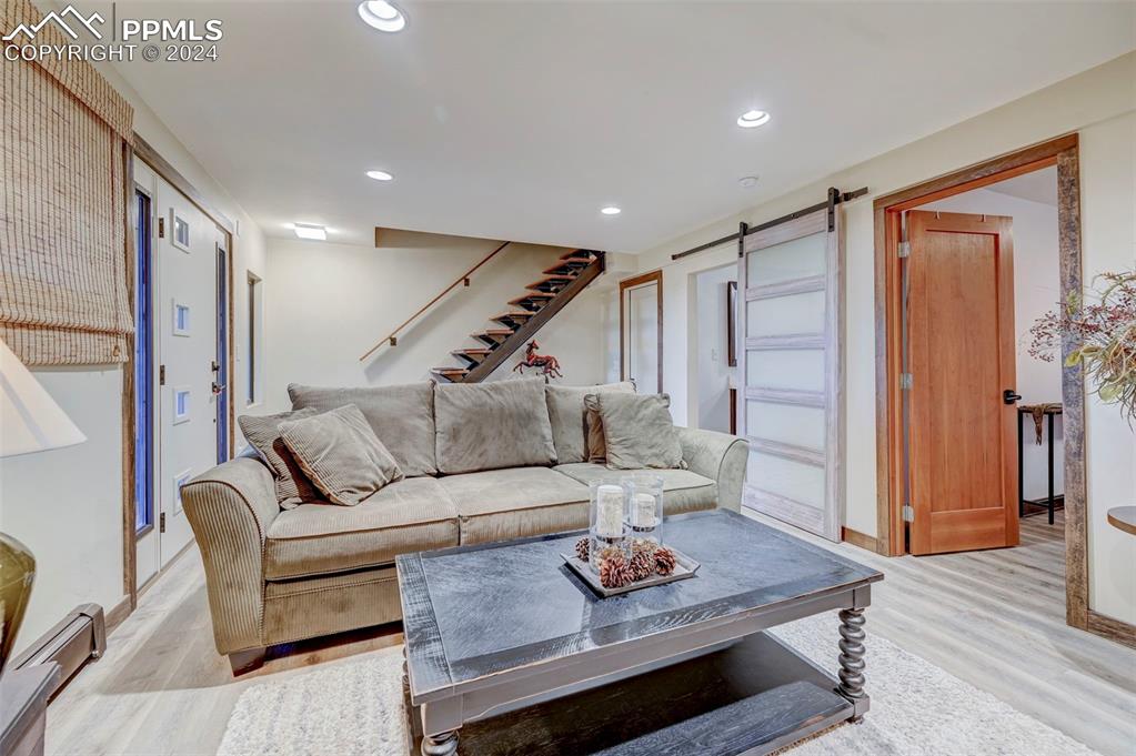 1306 Limerock Lane Colorado Springs, CO 80906 - Photo 7 of 50 a living room with furniture and a wooden floor