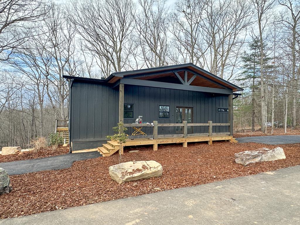 a backyard of a house with outdoor seating