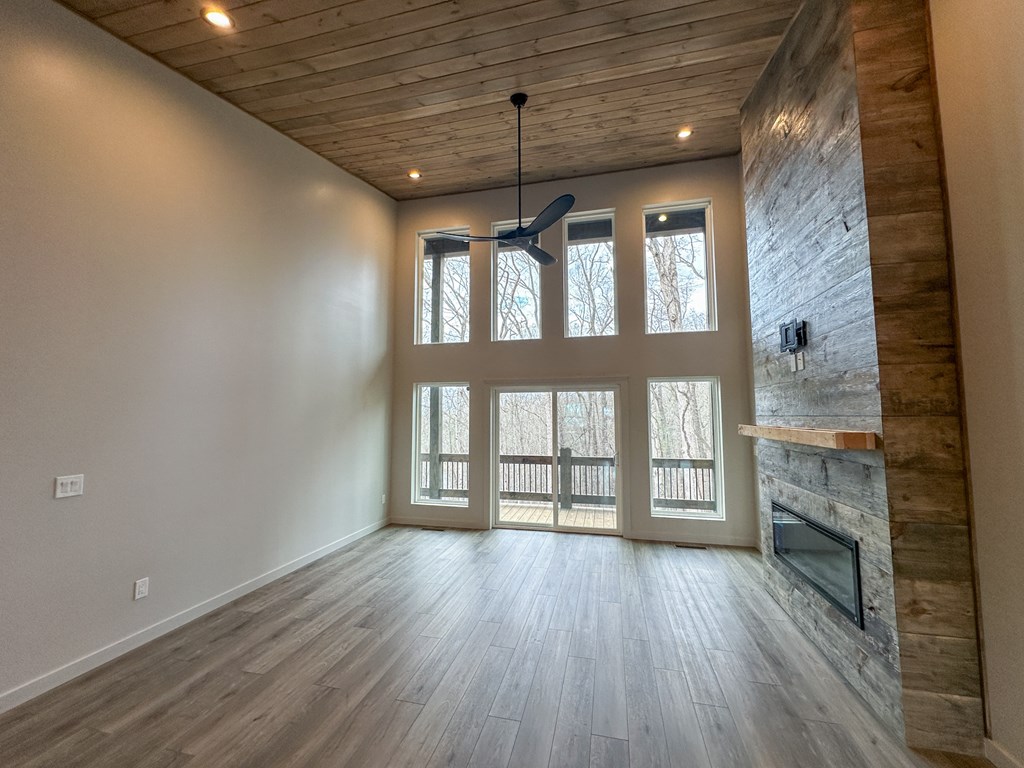 660 Old Toccoa Road Morganton, GA 30560 - Photo 18 of 45 a view of an empty room with a window and wooden floor
