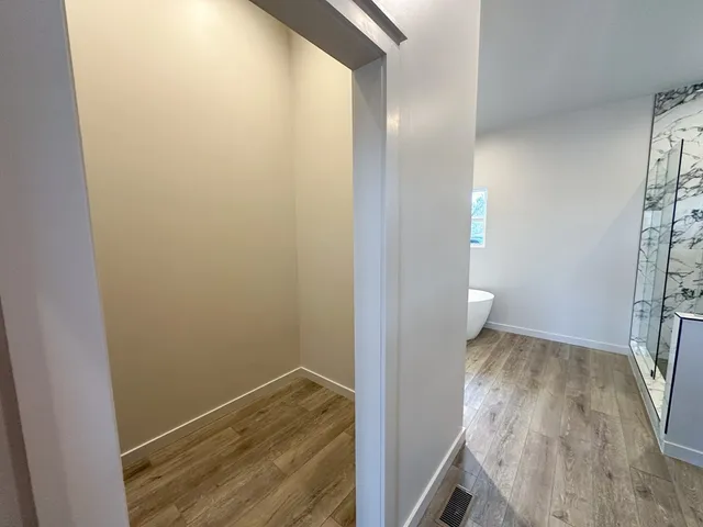 a view of a room with wooden floor and staircase