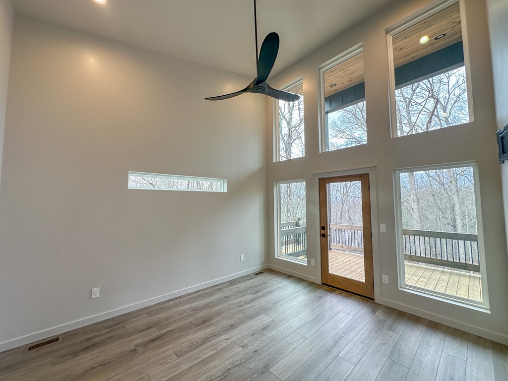 660 Old Toccoa Road Morganton, GA 30560 - Photo 22 of 45 a view of an empty room with a window and wooden floor