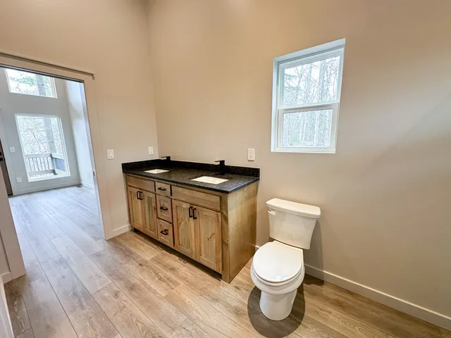 a bathroom with a toilet a sink and a window