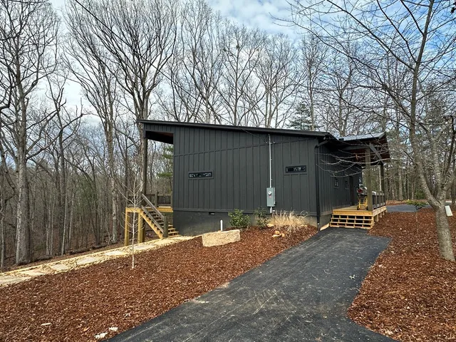 a backyard of house with table and chairs