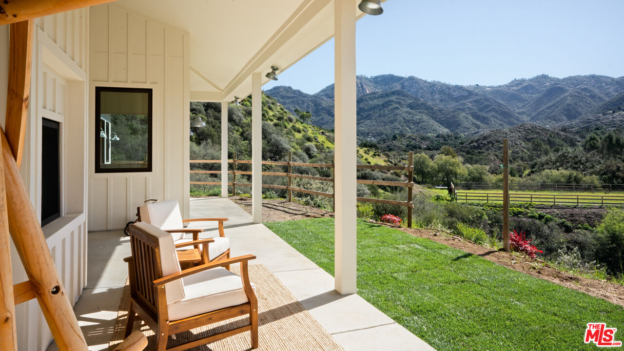 a view of a patio with a table chairs and a backyard