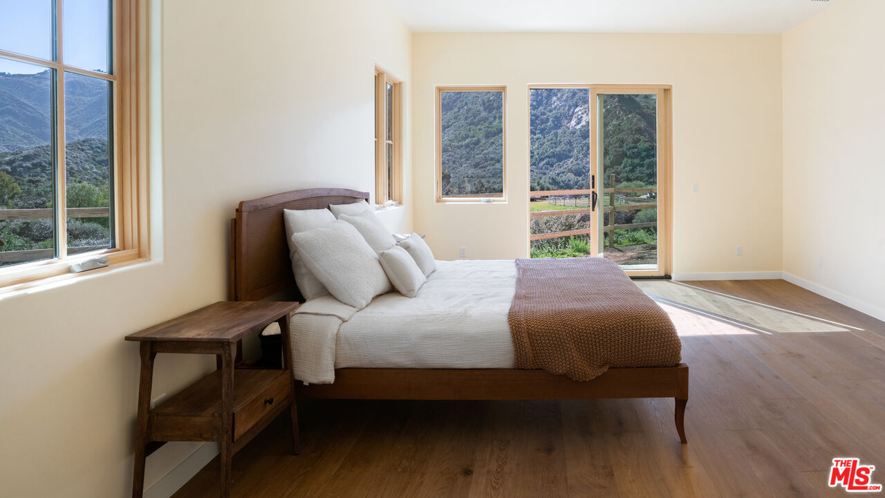 26255 Piuma Road Calabasas, CA 91302 - Photo 15 of 24 a bedroom with a bed and a window