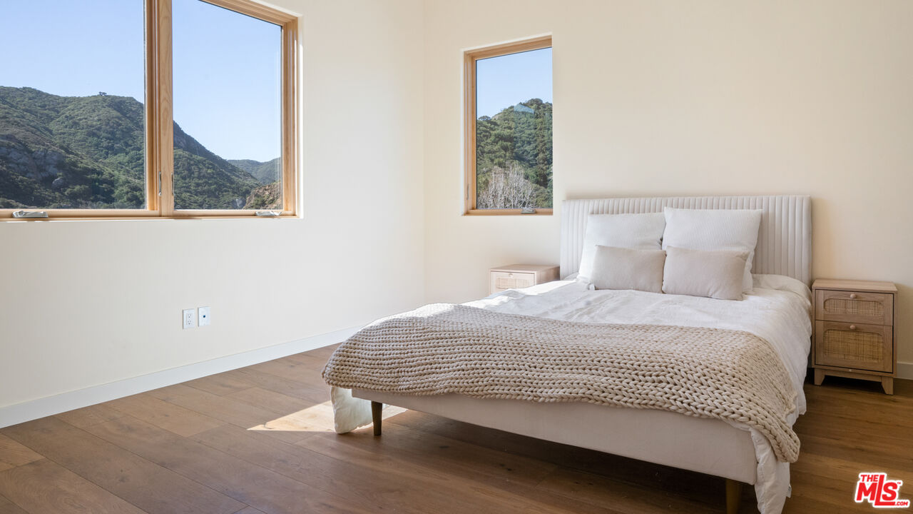 26255 Piuma Road Calabasas, CA 91302 - Photo 17 of 24 a bedroom with a bed and a window