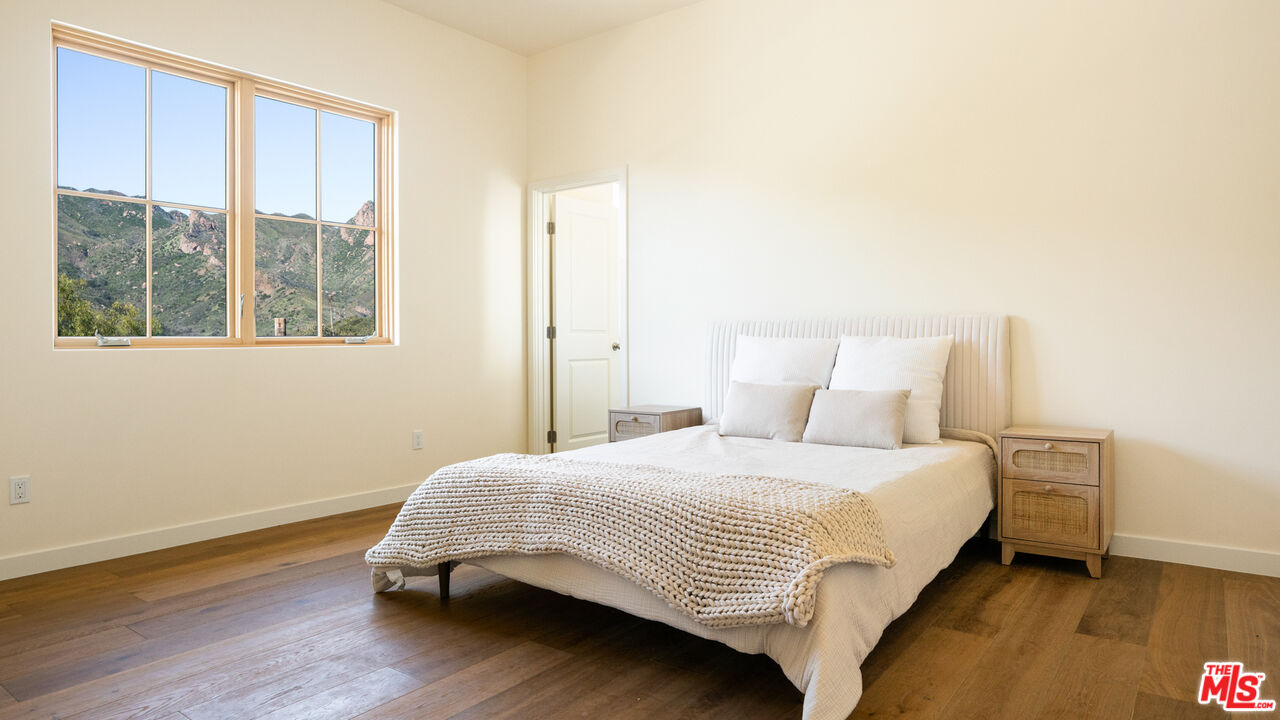 26255 Piuma Road Calabasas, CA 91302 - Photo 22 of 24 a bedroom with a bed and a window