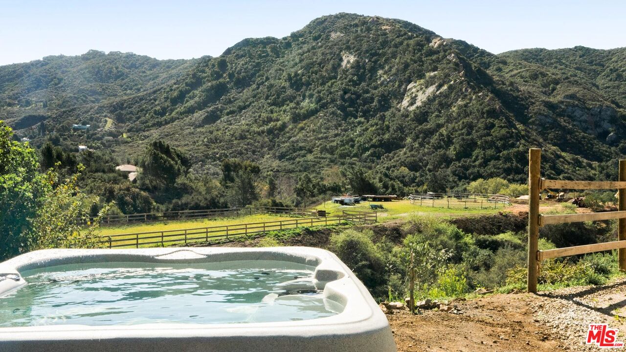 26255 Piuma Road Calabasas, CA 91302 - Photo 5 of 24 a view of a swimming pool with a yard