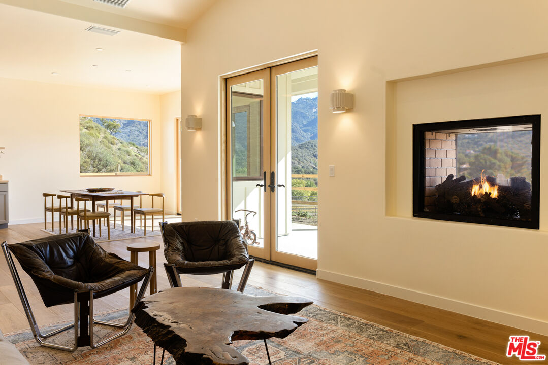26255 Piuma Road Calabasas, CA 91302 - Photo 8 of 24 a living room with furniture and a painting on the wall