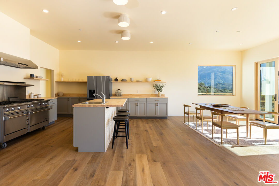 26255 Piuma Road Calabasas, CA 91302 - Photo 10 of 24 a living room with furniture and a kitchen view
