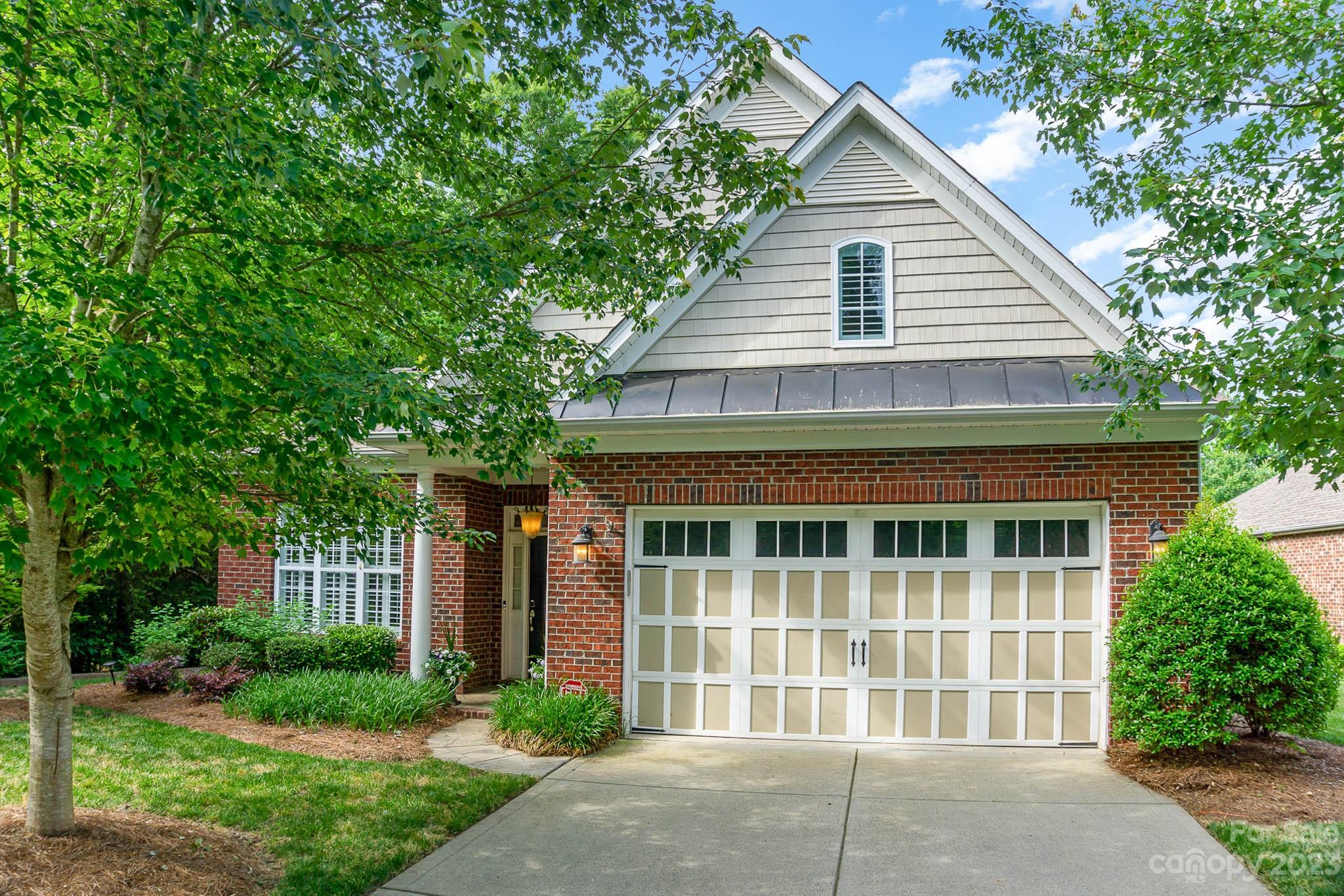 4922 Spur Ranch Road Charlotte, NC 28277 - Photo 1 of 33 a front view of a house with a garden