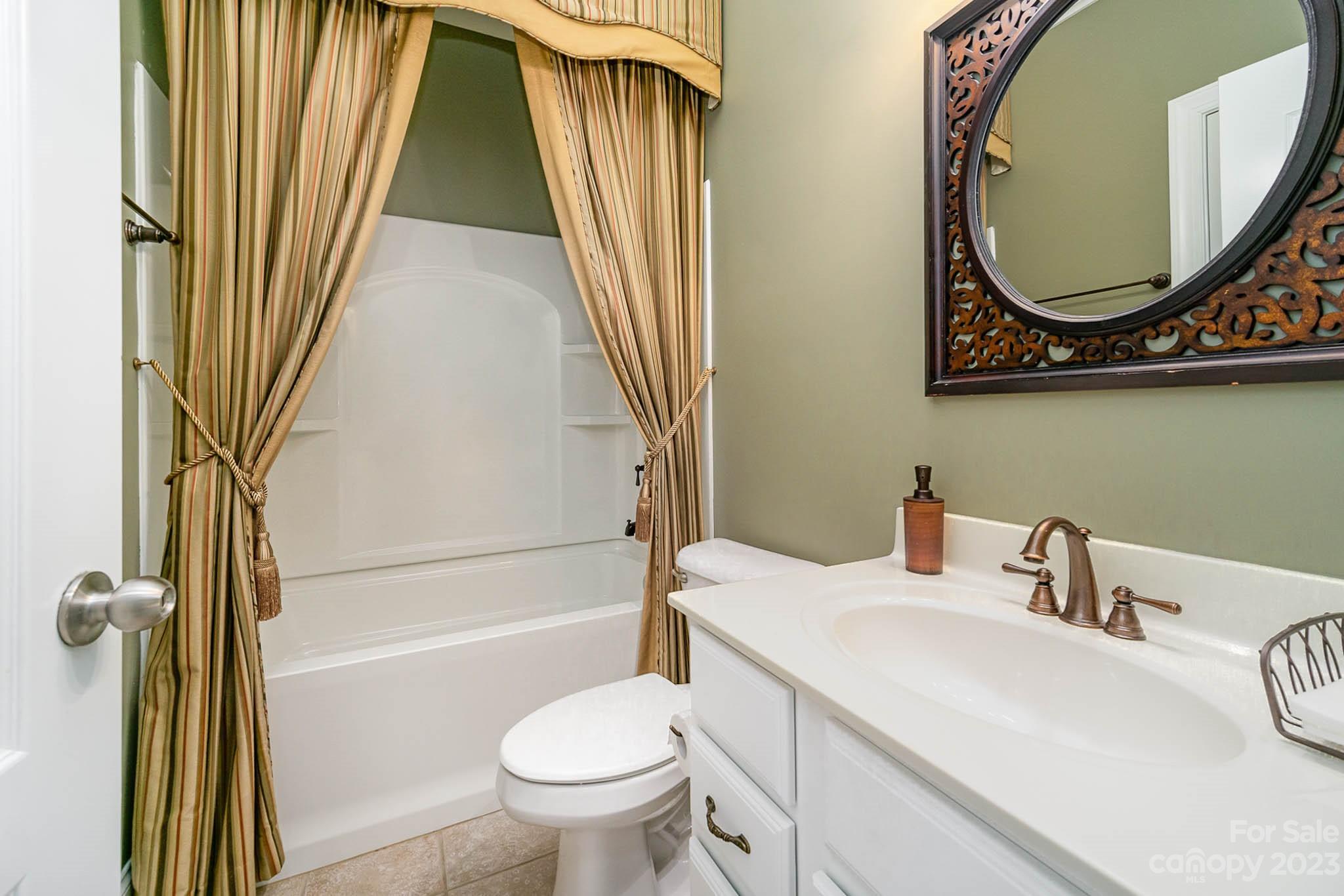 4922 Spur Ranch Road Charlotte, NC 28277 - Photo 20 of 33 a bathroom with a sink a toilet and a mirror