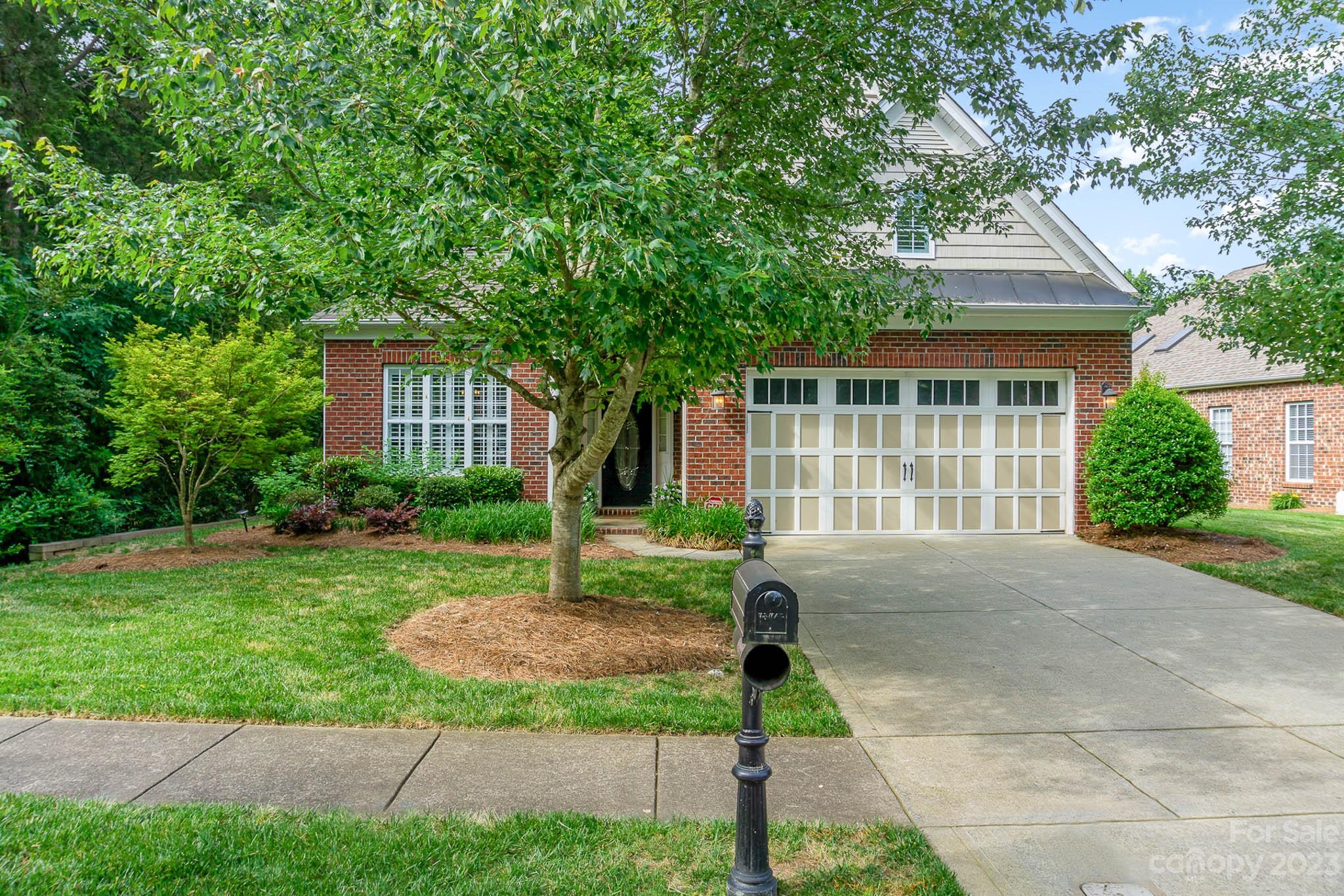 4922 Spur Ranch Road Charlotte, NC 28277 - Photo 2 of 33 a front view of a house with a yard and plants