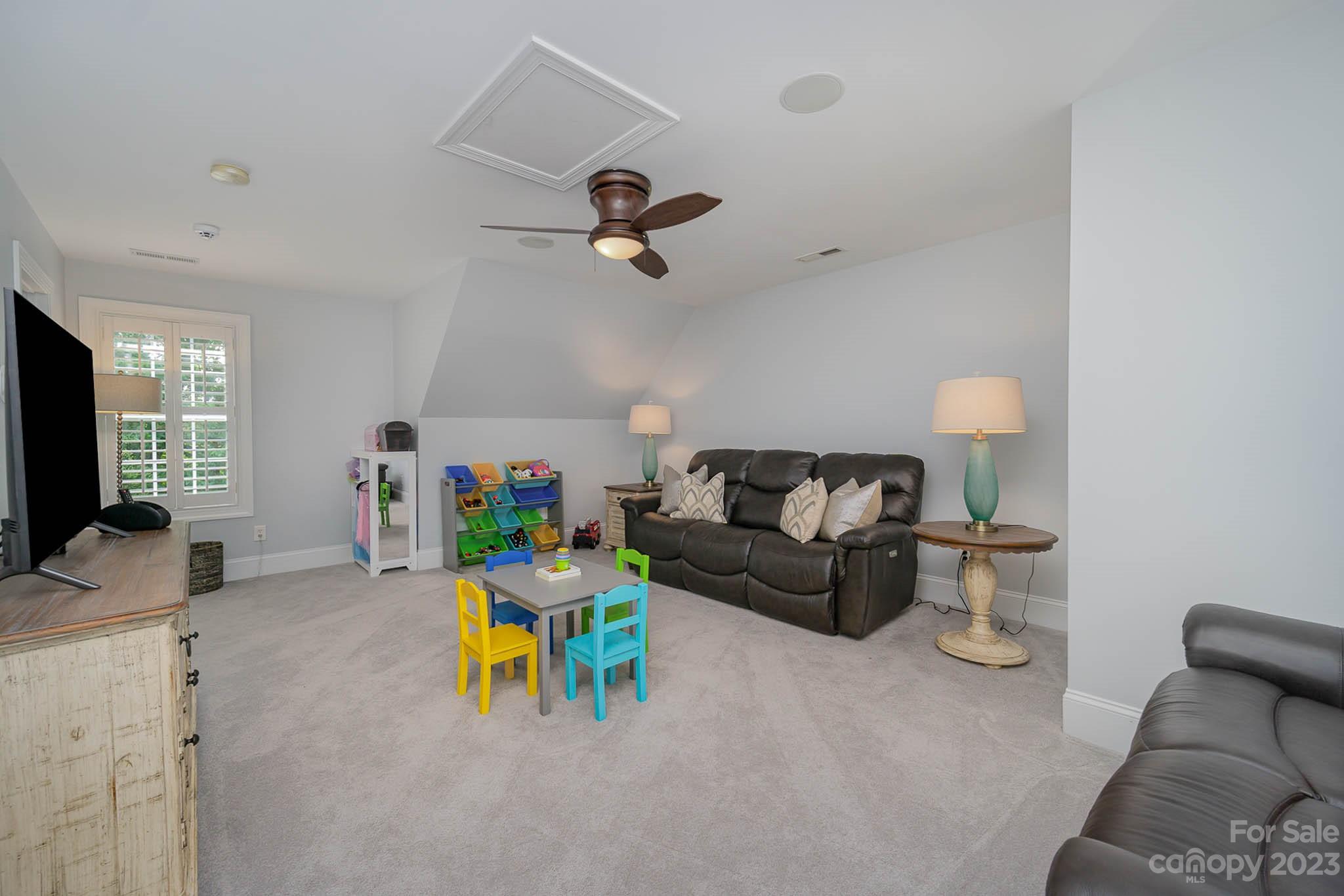 4922 Spur Ranch Road Charlotte, NC 28277 - Photo 22 of 33 a living room with furniture and a flat screen tv
