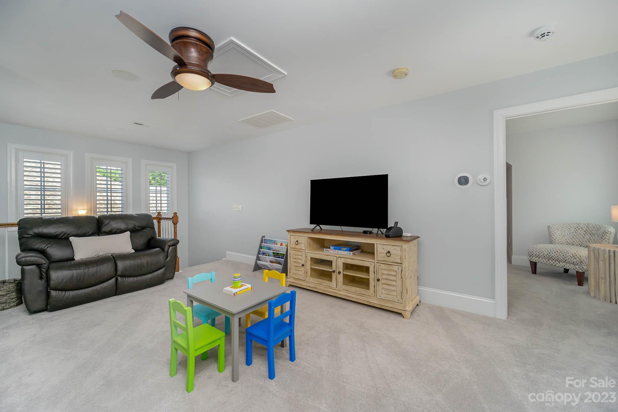 4922 Spur Ranch Road Charlotte, NC 28277 - Photo 23 of 33 a living room with furniture and a flat screen tv
