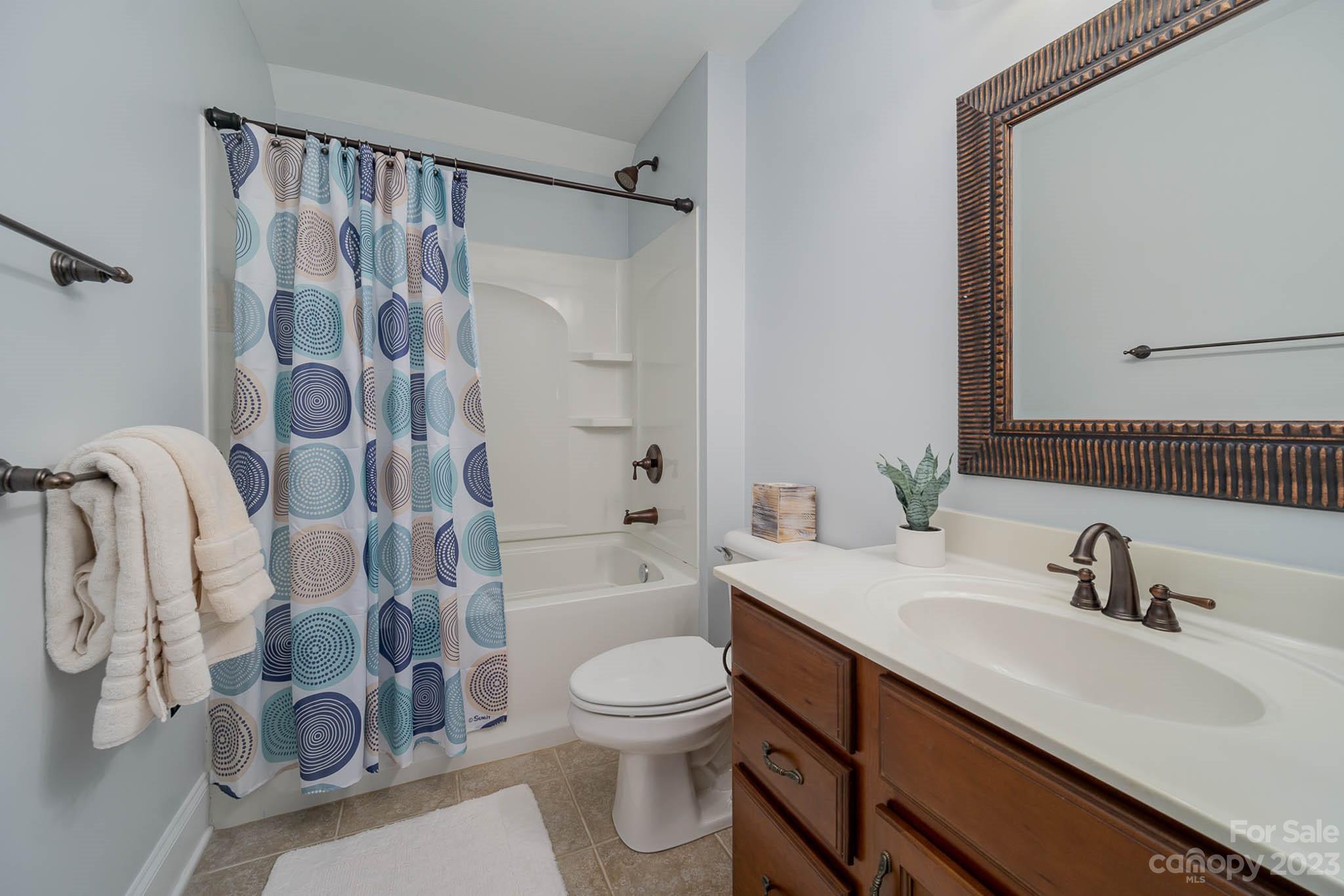 4922 Spur Ranch Road Charlotte, NC 28277 - Photo 25 of 33 a bathroom with a sink toilet a shower and a mirror