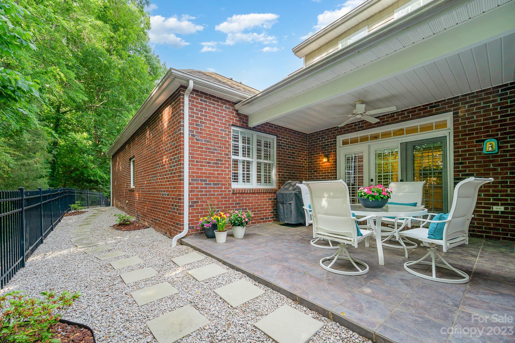4922 Spur Ranch Road Charlotte, NC 28277 - Photo 29 of 33 a view of a patio with table and chairs and potted plants